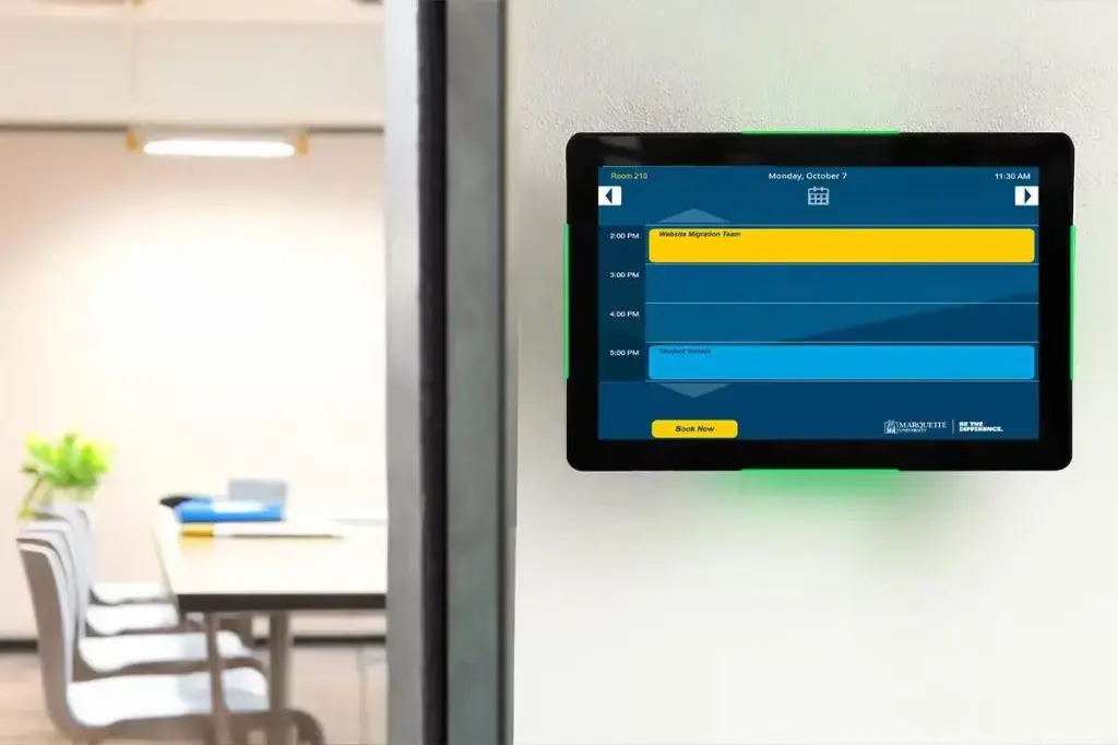 Portrait room panel with green LED beside glass meeting room.webp